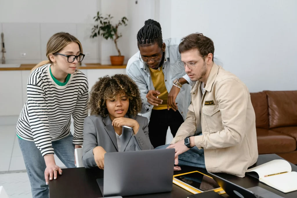 all team mates in front of a computer discussing something important